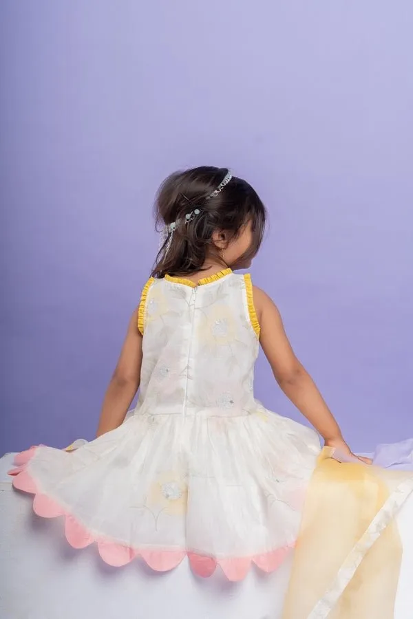 Charming white dhoti-style set with floral embroidery and playful yellow and pink accents, perfect for festive occasions